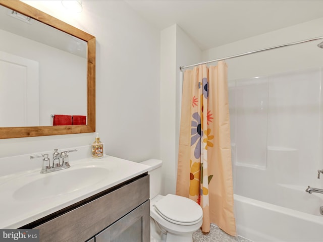 full bathroom featuring vanity, toilet, visible vents, and shower / tub combo with curtain