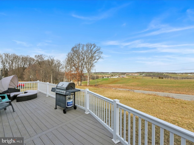 wooden terrace featuring a lawn and grilling area