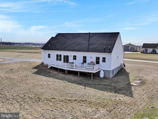 back of house featuring a deck and a shingled roof