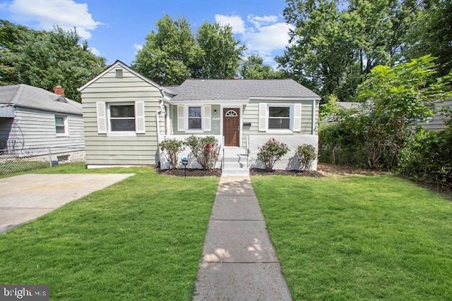 view of front of house with a front yard and fence