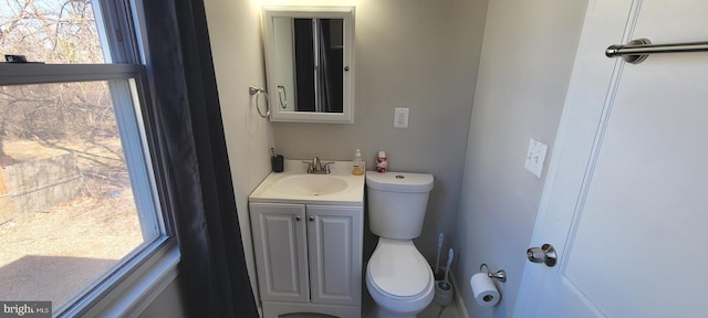 half bathroom featuring vanity and toilet