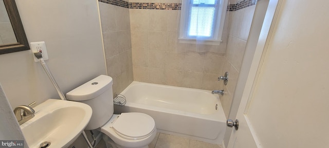 bathroom featuring washtub / shower combination, a sink, and toilet