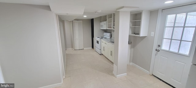 kitchen with glass insert cabinets, white appliances, white cabinets, and baseboards