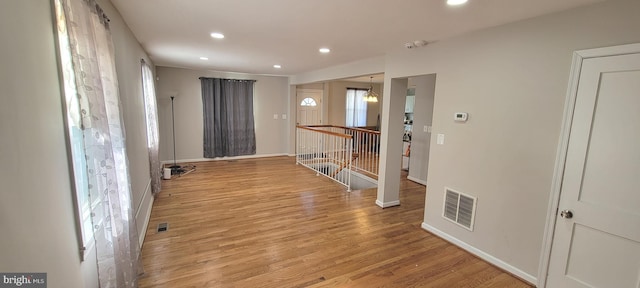 foyer entrance featuring recessed lighting, visible vents, baseboards, and wood finished floors