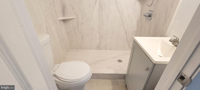 full bath featuring a stall shower, vanity, toilet, and tile patterned floors