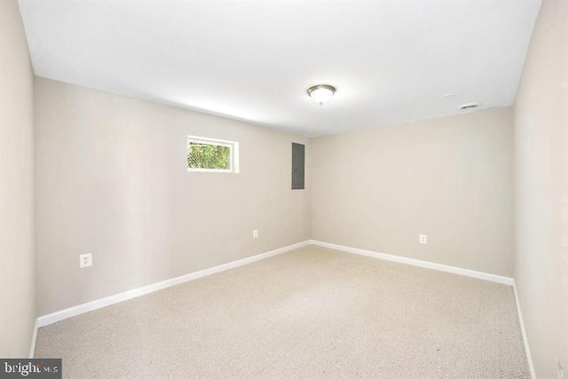 unfurnished room featuring carpet and baseboards