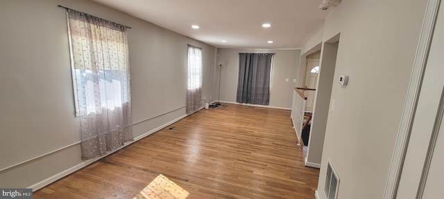 unfurnished room featuring recessed lighting, baseboards, and wood finished floors