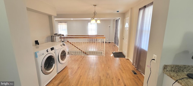 laundry area featuring light wood-style floors, laundry area, visible vents, and washing machine and clothes dryer