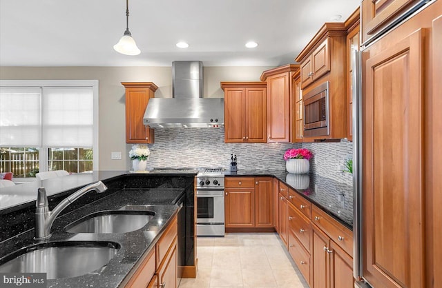 kitchen with built in appliances, brown cabinets, wall chimney exhaust hood, and a sink