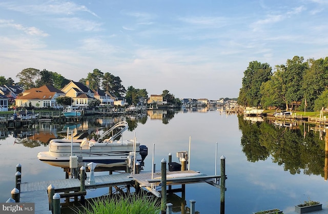 dock area with a water view and boat lift