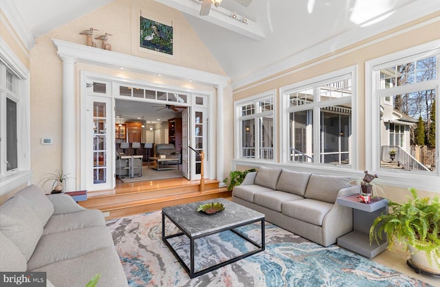 sunroom featuring vaulted ceiling and ceiling fan