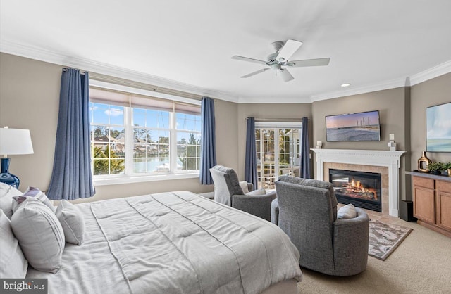 bedroom with a ceiling fan, light colored carpet, a fireplace, and crown molding