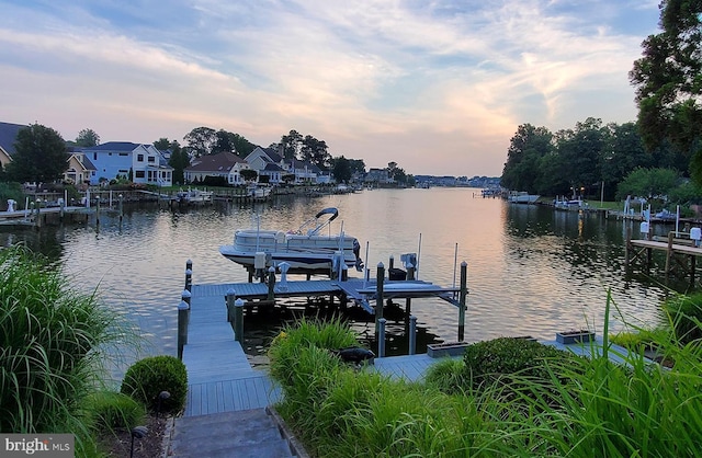 dock area featuring a residential view, a water view, and boat lift