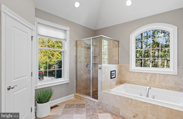 full bath with a wealth of natural light, a shower stall, a bath, and lofted ceiling