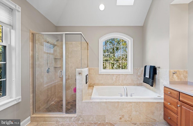 full bath with vanity, lofted ceiling, a garden tub, and a shower stall