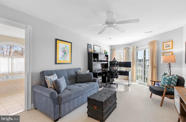 living room with visible vents, ceiling fan, and carpet