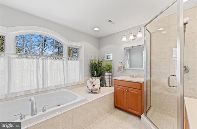 full bath featuring vanity, a shower stall, a bath, and visible vents