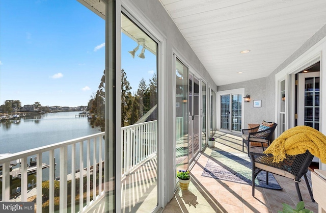 sunroom / solarium with a water view