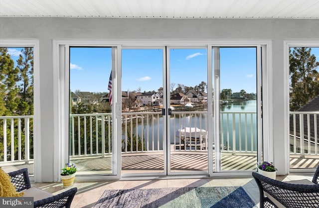 sunroom with a healthy amount of sunlight and a water view