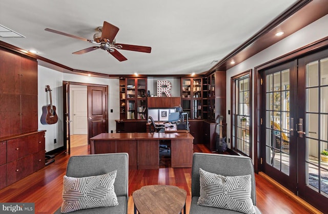 office with a ceiling fan, french doors, dark wood-style flooring, and ornamental molding