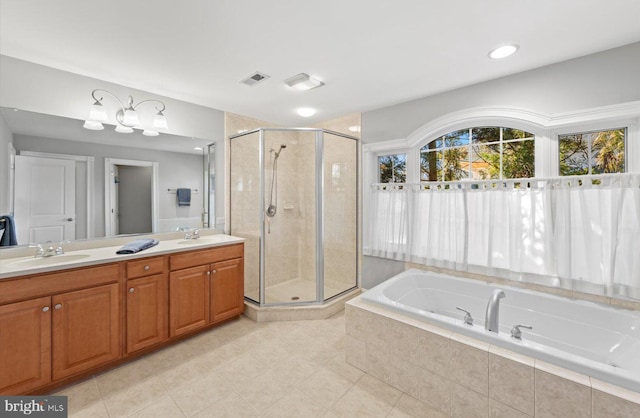 bathroom with a bath, a shower stall, and a sink