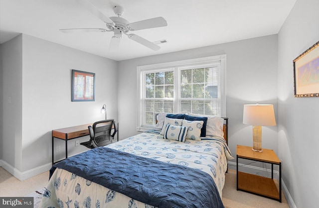 carpeted bedroom featuring baseboards, visible vents, and ceiling fan