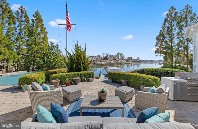 view of patio / terrace with a grill, a water view, and an outdoor hangout area