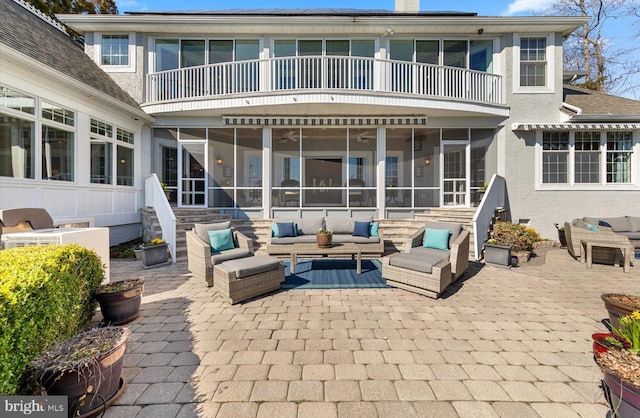 view of patio / terrace featuring an outdoor hangout area, a balcony, and a sunroom