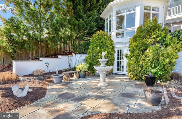 view of patio / terrace featuring french doors and fence