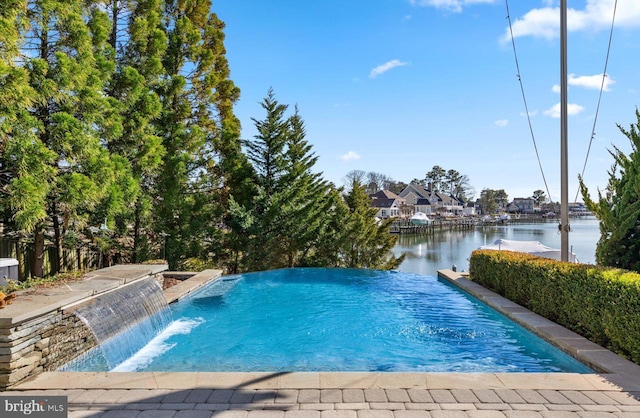 view of swimming pool with a water view