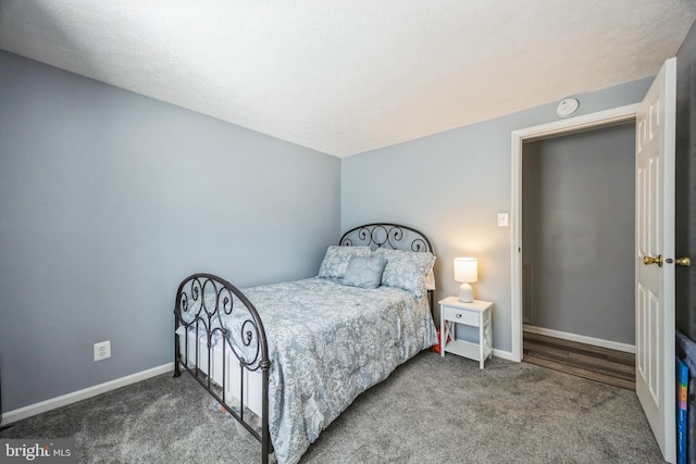 bedroom featuring carpet flooring and baseboards