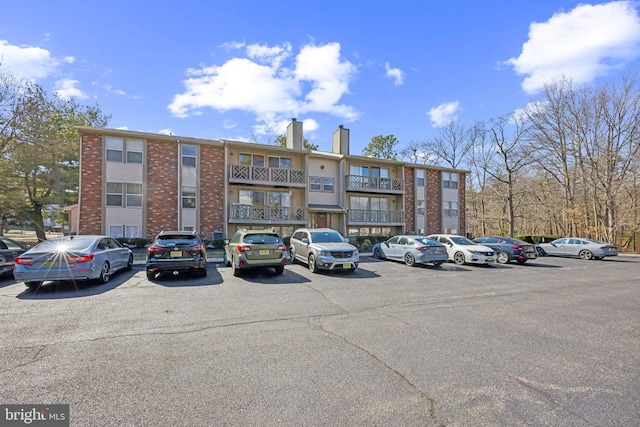 view of building exterior with uncovered parking