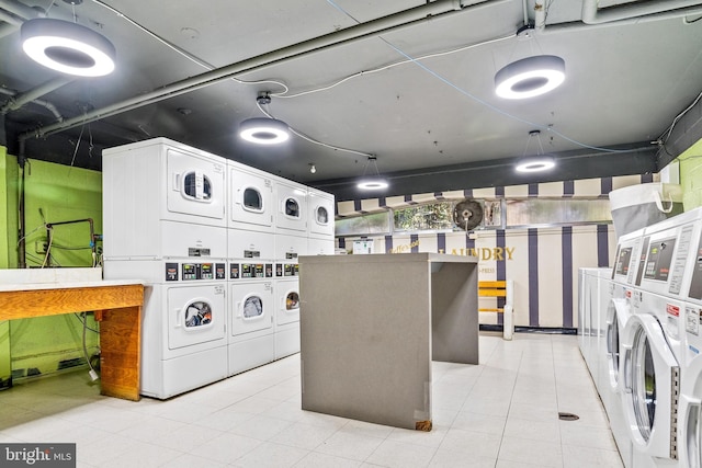 shared laundry area featuring washing machine and clothes dryer and stacked washing maching and dryer