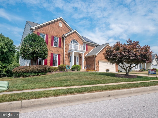 view of front facade featuring an attached garage, a balcony, brick siding, concrete driveway, and a front yard