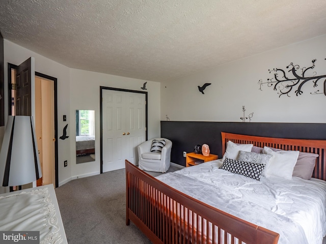 bedroom featuring carpet and a textured ceiling