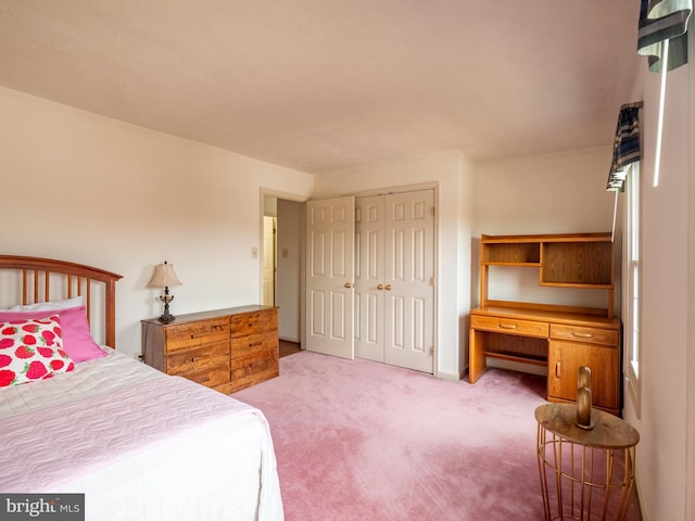 bedroom featuring light carpet, a closet, and built in study area