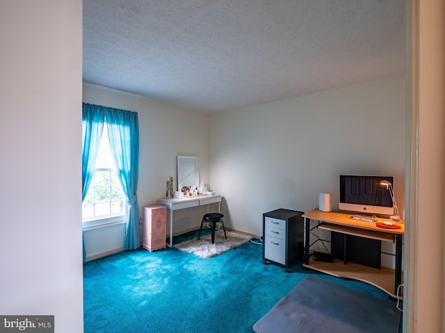 carpeted office featuring a textured ceiling and baseboards