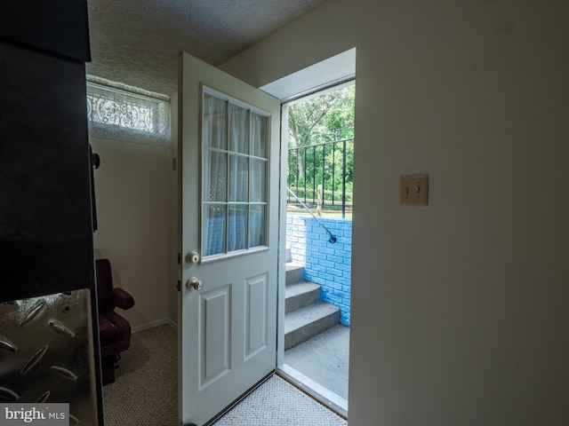 entryway featuring a textured ceiling