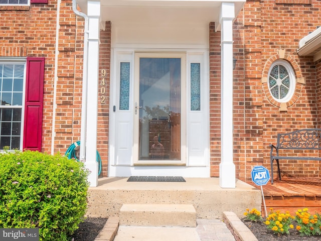 entrance to property with brick siding