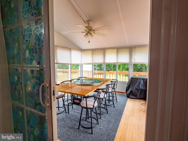 sunroom with ceiling fan and vaulted ceiling