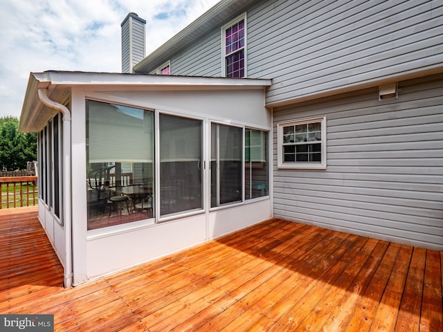 wooden deck with a sunroom