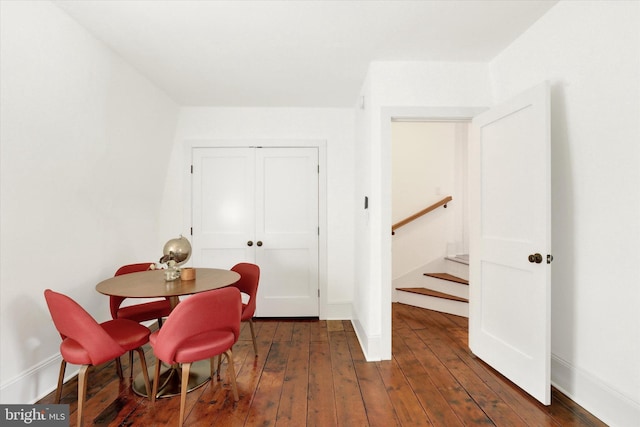 dining room featuring baseboards and dark wood-type flooring