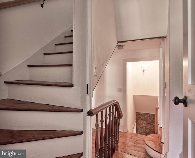 stairs featuring wood finished floors