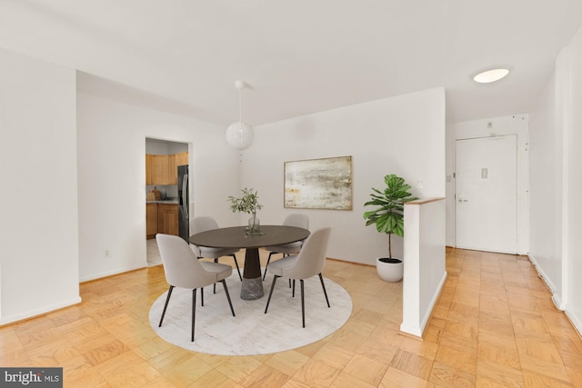 dining area featuring baseboards