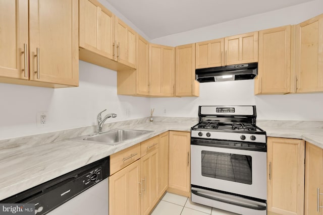 kitchen featuring stainless steel gas stove, light brown cabinetry, and under cabinet range hood