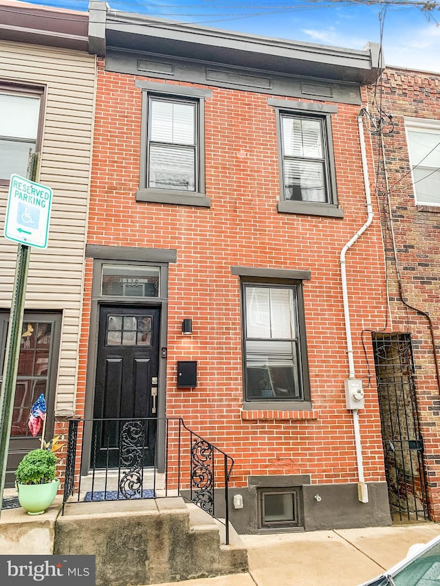 view of front of home featuring brick siding