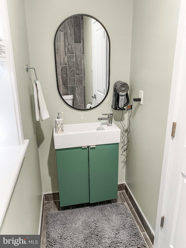 bathroom with baseboards and vanity