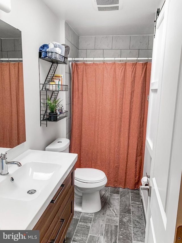 bathroom with visible vents, toilet, vanity, and a shower with curtain