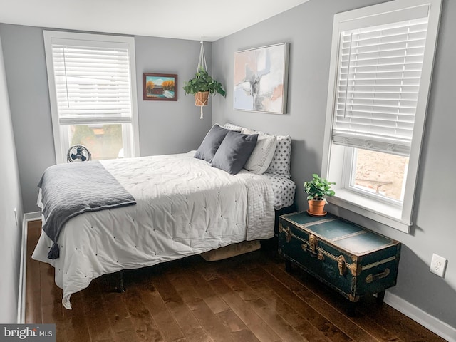 bedroom with baseboards and wood finished floors