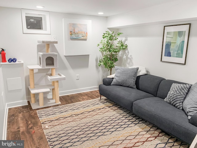 living room featuring recessed lighting, baseboards, and wood finished floors